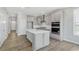 Well-designed kitchen with gray cabinets, a spacious island, stainless steel appliances, and elegant hardwood flooring at 13324 Roundtop Rd, Noblesville, IN 46060