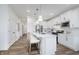 Charming kitchen features a center island with white cabinets, pendant lighting, and stainless steel appliances at 13324 Roundtop Rd, Noblesville, IN 46060