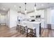 Open kitchen with white cabinetry, stainless steel appliances, and island seating at 13324 Roundtop Rd, Noblesville, IN 46060