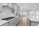 Bright kitchen showcasing gray cabinets, countertops, stainless steel appliances, and elegant hardwood floors at 13324 Roundtop Rd, Noblesville, IN 46060