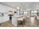 Bright kitchen boasts white cabinets, stainless steel appliances, and a large island with bar stool seating at 13324 Roundtop Rd, Noblesville, IN 46060