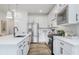 Modern kitchen with white cabinets, stainless steel appliances, island with sink, and lots of counter space at 13324 Roundtop Rd, Noblesville, IN 46060
