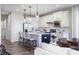 Open-concept kitchen with stainless steel appliances, island seating, and natural light at 13324 Roundtop Rd, Noblesville, IN 46060