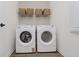 Laundry room featuring a white Whirlpool washer and dryer set with a shelf above at 13324 Roundtop Rd, Noblesville, IN 46060