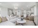 Bright, open-concept living room features modern decor and seamless flow to the kitchen, perfect for entertaining and daily living at 13324 Roundtop Rd, Noblesville, IN 46060