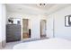 Bright main bedroom featuring a tray ceiling with modern light fixture, neutral walls, and stylish dresser at 13324 Roundtop Rd, Noblesville, IN 46060