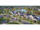 Scenic aerial view of a vibrant community surrounding a tranquil lake, showcasing lush landscapes and charming homes at 13355 Seven Springs Ln, Noblesville, IN 46060