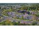 Aerial view of community clubhouse featuring pool, seating areas, tennis courts, and beautiful landscaping at 13355 Seven Springs Ln, Noblesville, IN 46060