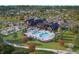 Aerial view of community clubhouse featuring pool, seating areas, tennis courts, and beautiful landscaping at 13355 Seven Springs Ln, Noblesville, IN 46060