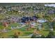Aerial view of community clubhouse featuring pool, seating areas, tennis courts, and beautiful landscaping at 13355 Seven Springs Ln, Noblesville, IN 46060