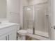 Bathroom with glass enclosed shower, single sink vanity, and neutral color palette at 13355 Seven Springs Ln, Noblesville, IN 46060