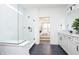 Bright bathroom featuring a large glass shower, white cabinets and granite countertops and view to bedroom at 13355 Seven Springs Ln, Noblesville, IN 46060