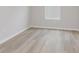 A simple bedroom with light hardwood floors and white trim at 13355 Seven Springs Ln, Noblesville, IN 46060