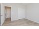 Bright bedroom with wood-look floors, closet, and fresh white trim at 13355 Seven Springs Ln, Noblesville, IN 46060