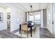 Bright dining room with modern decor, featuring a stylish light fixture and large windows at 13355 Seven Springs Ln, Noblesville, IN 46060