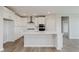 This spacious kitchen boasts a large center island, stainless steel appliances, and crisp white cabinetry at 13355 Seven Springs Ln, Noblesville, IN 46060