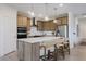 Bright eat-in kitchen features stainless appliances, wood cabinetry and pendant lighting at 13355 Seven Springs Ln, Noblesville, IN 46060