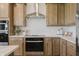 Kitchen featuring stainless steel range hood, range, and backsplash at 13355 Seven Springs Ln, Noblesville, IN 46060
