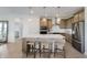 Well-lit kitchen with large island, pendant lighting, stainless appliances, and seating for three at 13355 Seven Springs Ln, Noblesville, IN 46060