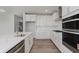 Well-appointed kitchen with stainless appliances, quartz countertops, and ample storage, perfect for cooking and entertaining at 13355 Seven Springs Ln, Noblesville, IN 46060