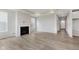 Spacious living room with fireplace, large windows, and sleek flooring, perfect for relaxing and entertaining guests at 13355 Seven Springs Ln, Noblesville, IN 46060