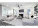 Bright living room with plush seating, a fireplace, and expansive windows for ample natural light at 13355 Seven Springs Ln, Noblesville, IN 46060