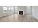 Living room with modern fireplace, light wood floors, and bright natural light at 13355 Seven Springs Ln, Noblesville, IN 46060
