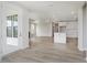Open-concept living room features wood floors and flows into the kitchen and dining area at 13355 Seven Springs Ln, Noblesville, IN 46060