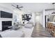 Open living space with modern fireplace, kitchen view, and contemporary decor at 13355 Seven Springs Ln, Noblesville, IN 46060
