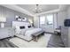 Serene main bedroom with tray ceiling, modern decor, and large window for natural light at 13355 Seven Springs Ln, Noblesville, IN 46060