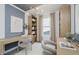 Modern office with a decorative chandelier, blue accent wall, and wood shelving unit at 13355 Seven Springs Ln, Noblesville, IN 46060