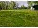 View of the backyard with large green storage shed at 1425 E Us Highway 40, Clayton, IN 46118