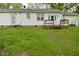 View of the backyard with small wood deck and entrance at 1425 E Us Highway 40, Clayton, IN 46118
