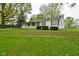 Quaint single story home with a long front porch and green shutters at 1425 E Us Highway 40, Clayton, IN 46118
