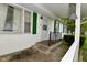 Inviting front entrance with storm door and green shutters at 1425 E Us Highway 40, Clayton, IN 46118