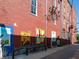 An alley features murals and decorative lighting along a red brick building at 1428 Aster Dr, Shelbyville, IN 46176