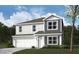 Charming two-story home featuring a two-car garage, gray siding, and white trim for a modern curb appeal at 1428 Aster Dr, Shelbyville, IN 46176