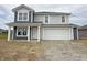 Charming two-story home with a two-car garage and inviting front porch at 1428 Aster Dr, Shelbyville, IN 46176