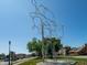 Modern metal sculpture in an outdoor setting, with a glimpse of downtown buildings at 1428 Aster Dr, Shelbyville, IN 46176