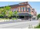 A red brick commercial building is viewed from the street, with awnings and outdoor seating at 1428 Aster Dr, Shelbyville, IN 46176