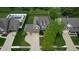 Aerial view of a two-story home with a well-manicured lawn, mature trees, and a spacious driveway at 18247 Kinder Oak Dr, Noblesville, IN 46062
