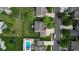 A lush backyard is featured with the home, a pool, patio and furniture set, and a manicured lawn at 18247 Kinder Oak Dr, Noblesville, IN 46062
