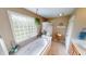 Bright bathroom showcasing a soaking tub, glass-block window, and stylish fixtures creating a relaxing space at 18247 Kinder Oak Dr, Noblesville, IN 46062