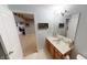 Bathroom featuring a double sink vanity and a view into the carpeted entertainment area at 18247 Kinder Oak Dr, Noblesville, IN 46062