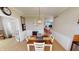 Dining area with farmhouse table, white chairs, and view of living room at 18247 Kinder Oak Dr, Noblesville, IN 46062