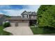 Two-story home with a three-car garage, brick facade, and well-manicured lawn at 18247 Kinder Oak Dr, Noblesville, IN 46062