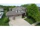 Aerial exterior showcasing a two-story home with a brick garage and driveway at 18247 Kinder Oak Dr, Noblesville, IN 46062
