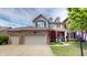 Charming two-story home with a brick and vinyl exterior, a well-manicured lawn, and an attached two-car garage at 18247 Kinder Oak Dr, Noblesville, IN 46062
