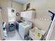 Functional laundry area featuring a washer, dryer, sink, and ample storage cabinets at 18247 Kinder Oak Dr, Noblesville, IN 46062