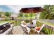 Relaxing outdoor patio with a grill, dining table, umbrella, and comfortable seating, perfect for entertaining at 18247 Kinder Oak Dr, Noblesville, IN 46062